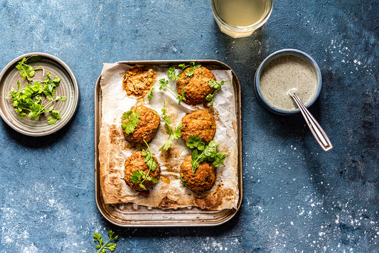 Our homemade Sweetcorn Pakoras; garnished with coriander and served with hot sauce.